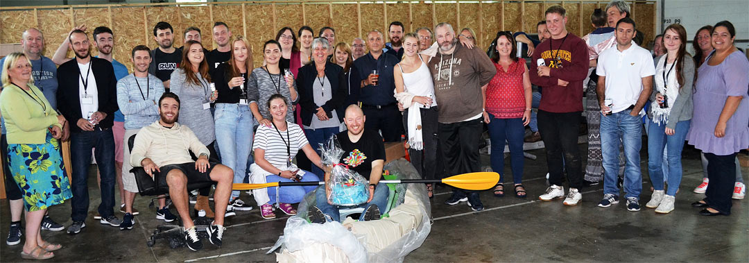 CCICM colleagues with Tom Dutton seated in his new kayak